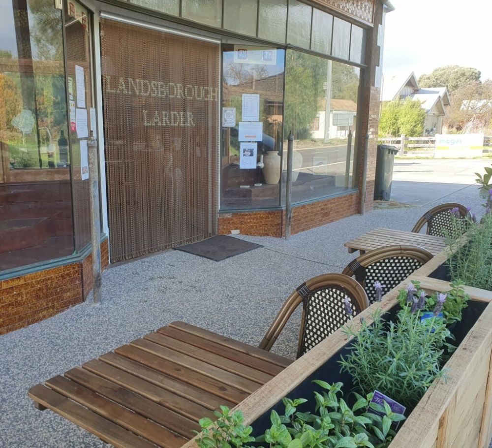 Bronze aluminium chain screen dividing a restaurant entrance from the dining area