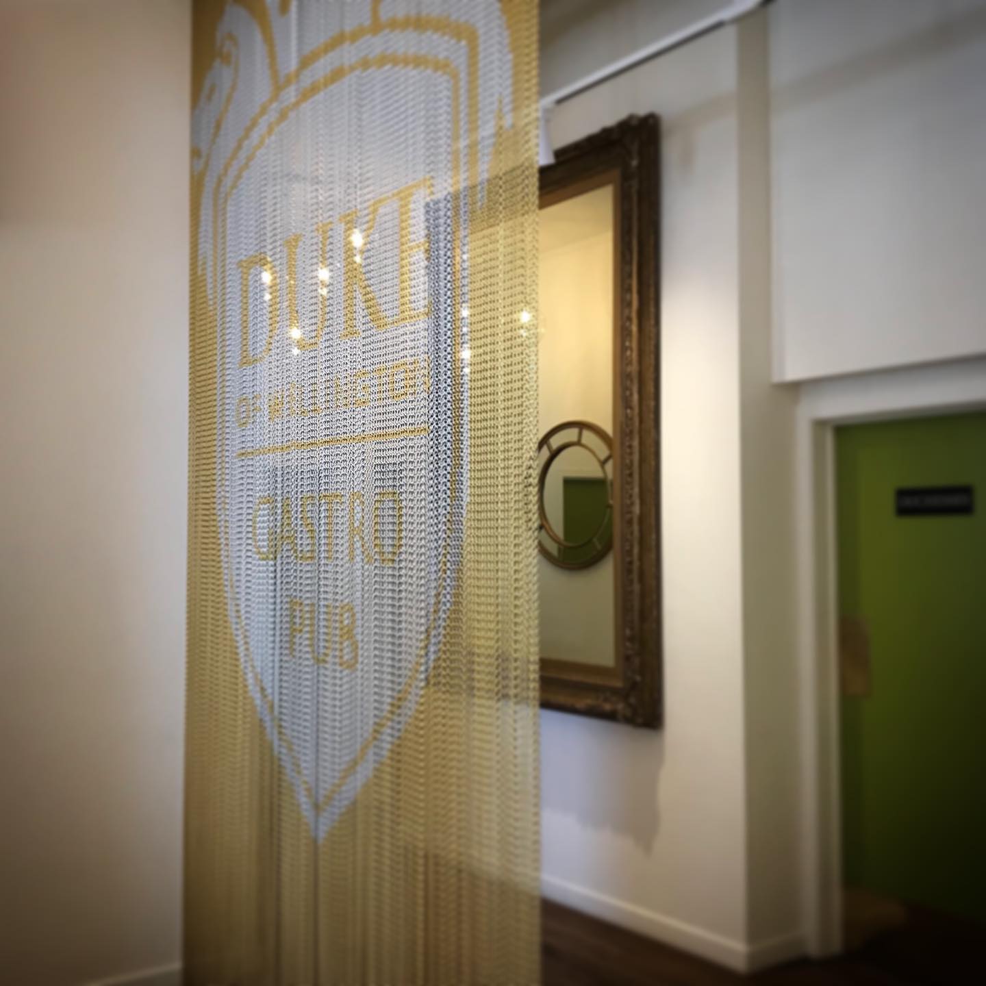 Gold and silver aluminium chain screen with the Duke of Wellington Gastro Pub logo