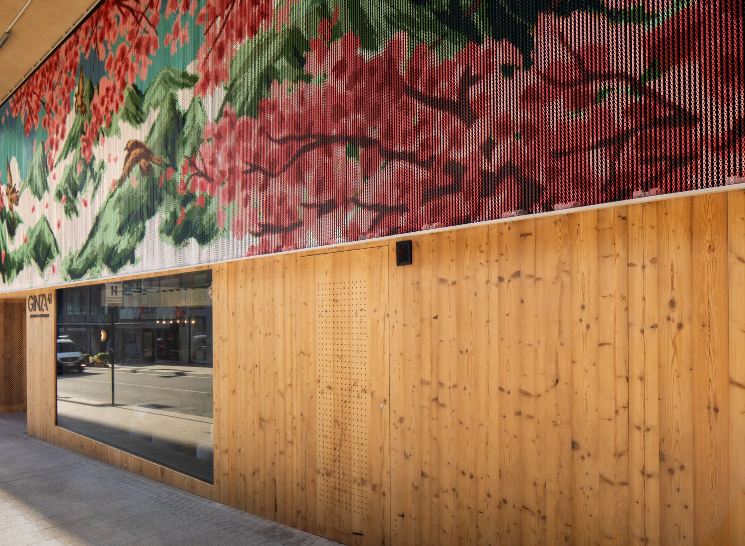 Aluminium chain mesh feature displaying a large-scale floral mural pattern on a Ginza shopfront exterior