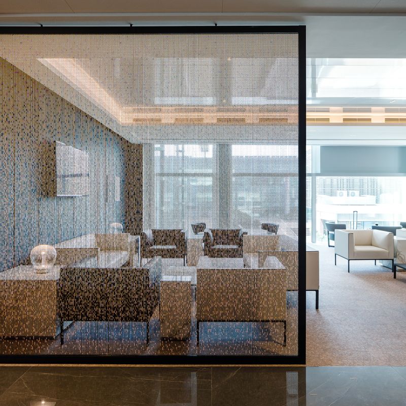 Chain feature curtain used as a room divider in a hotel lounge setting