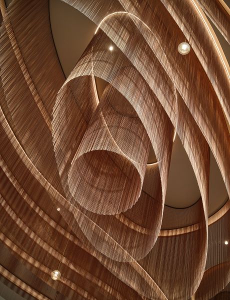 Sculptural chain ceiling feature with swirling ribbon design and embedded lights